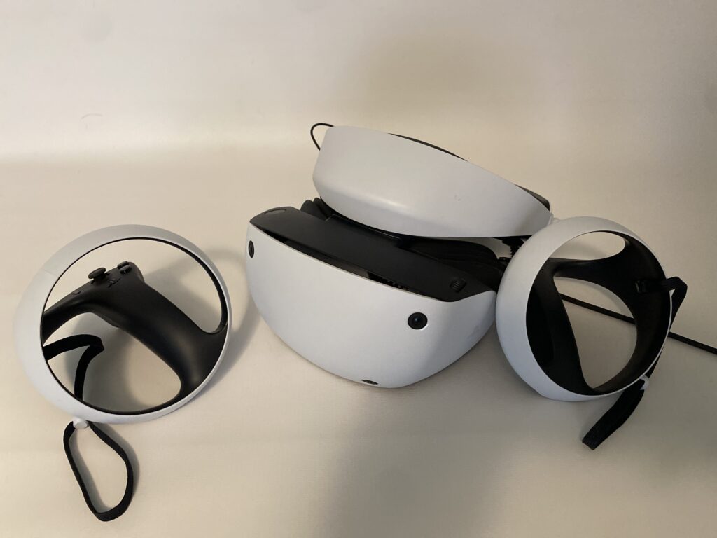 PSVR2 headset with wireless controllers on white background